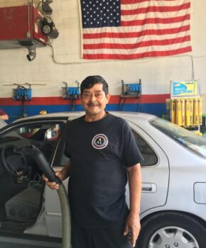 American Lube Employee in front of car